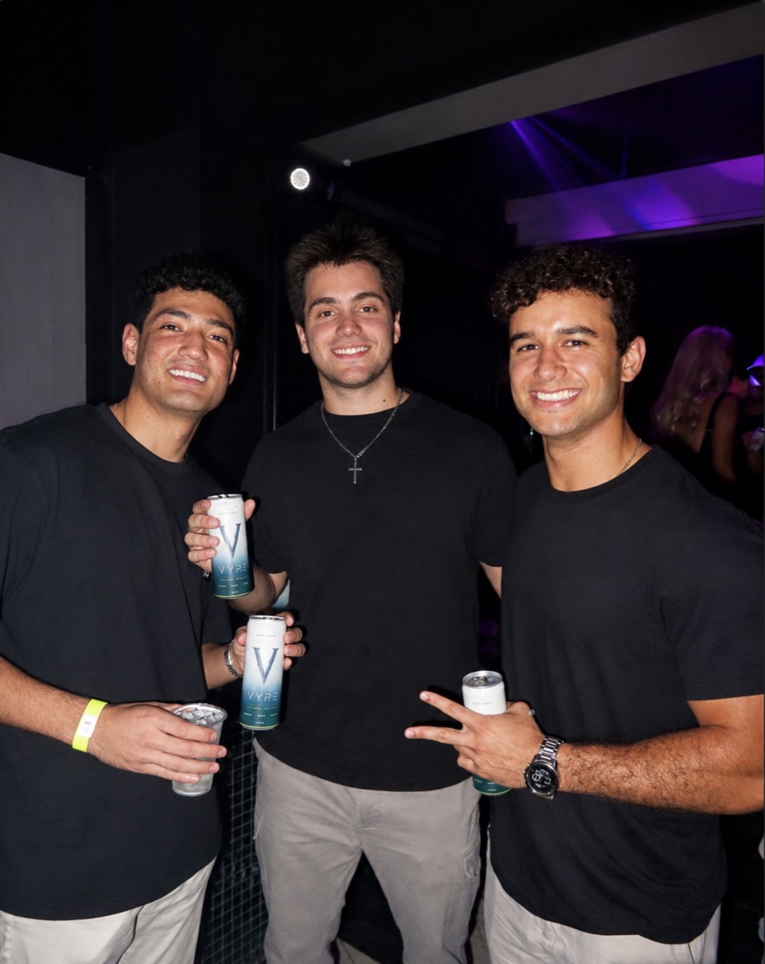 A crew with VYRE cans on the dance floor