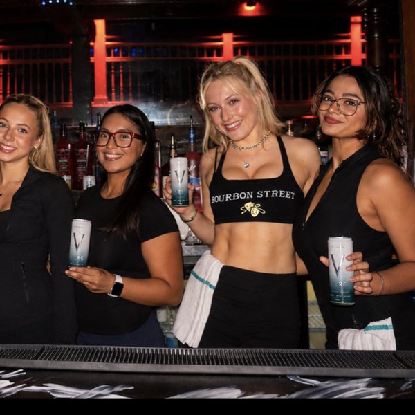 Bourbon Street bartenders holding VYRE cans
